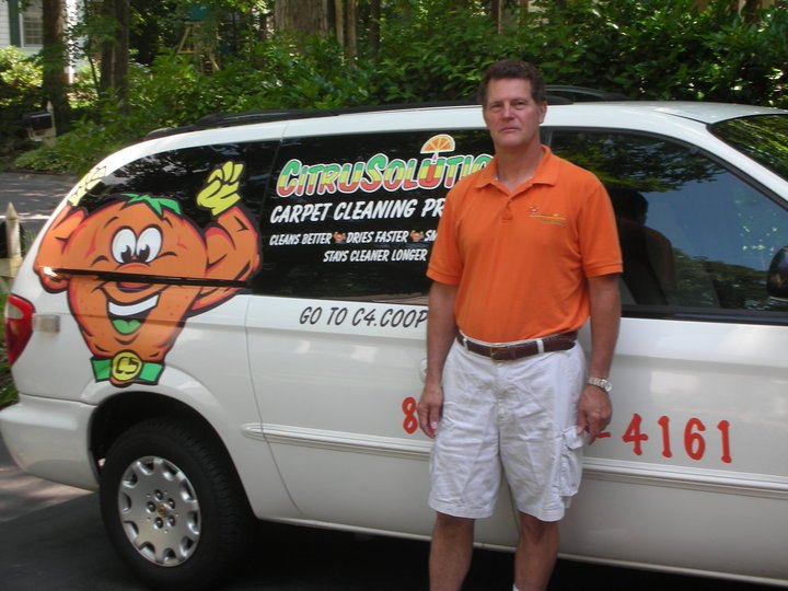 CitruSolution van with the orange mascot and Cleans Better, Dries Faster, Stays Cleaner Longer on the doors